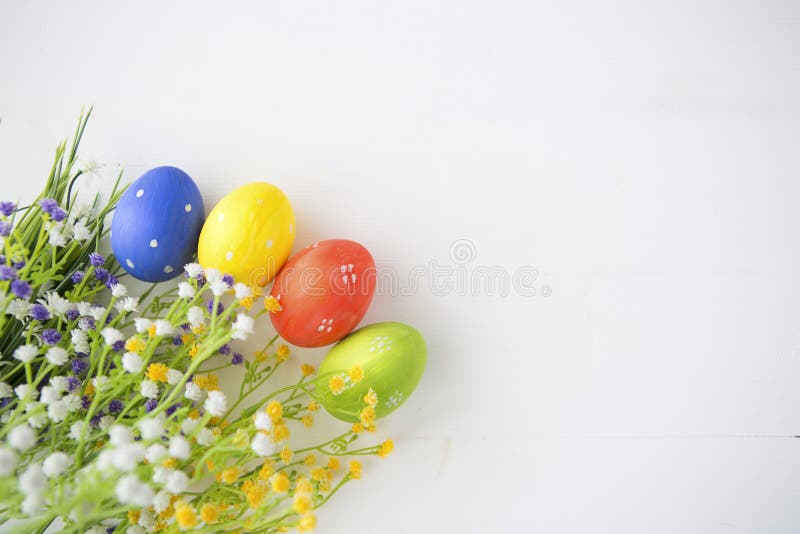 Colorful decorated easter eggs on white wood background. royalty free stock photo