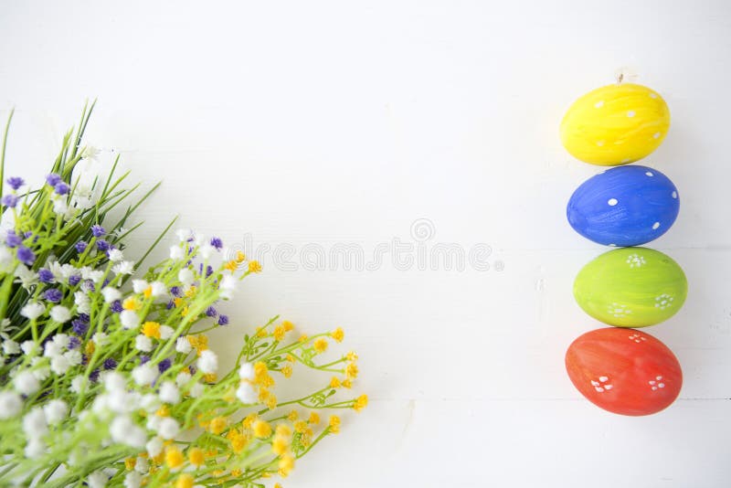 Colorful decorated easter eggs on white wood background. stock photo