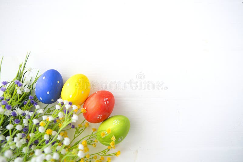 Colorful decorated easter eggs on white wood background. stock image