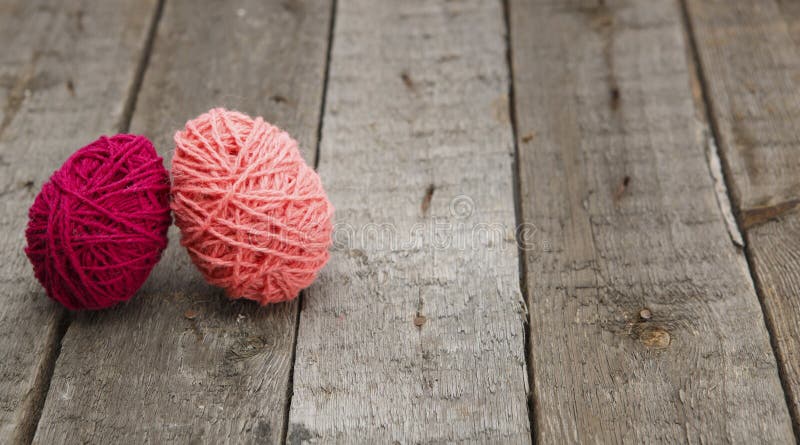 Colorful decorated easter eggs from wool yarn on wood. stock images