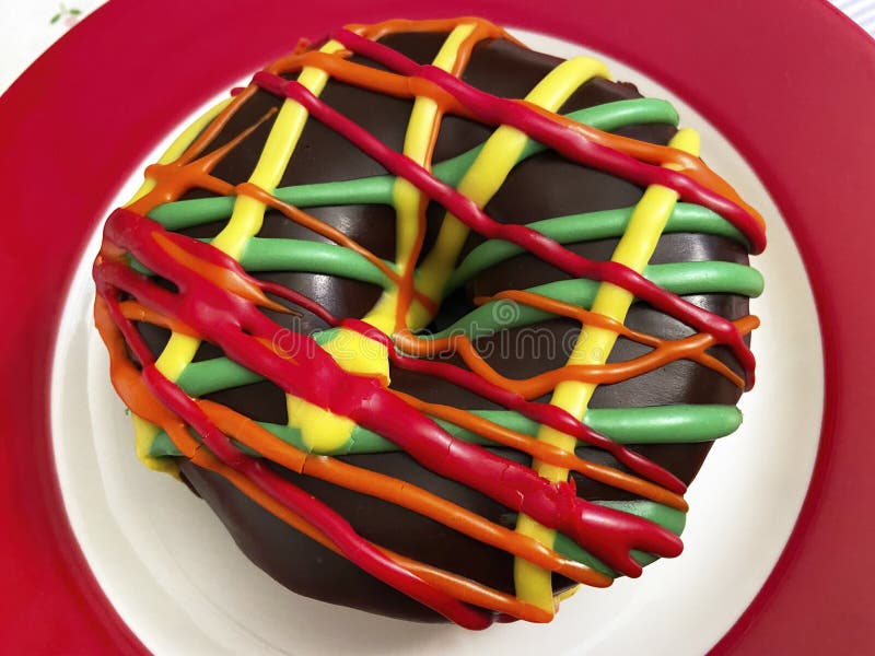 Colorful Donut on a Red Holiday Plate stock image