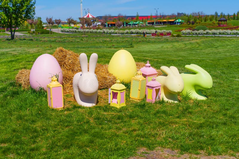 Colorful Easter Decorations In A Park Setting With Bunnies And Lanterns stock photos