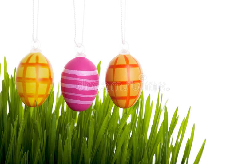 Colorful Easter eggs above the grass
