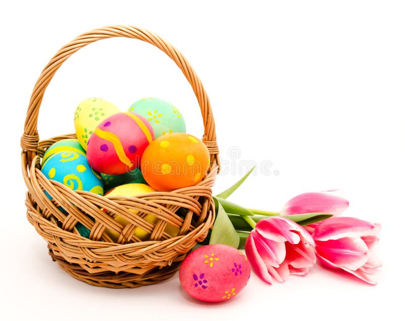 Colorful easter eggs in basket and flowers