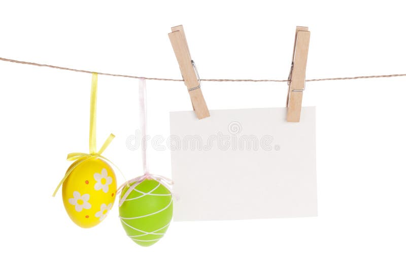 Colorful easter eggs and blank photo frame hanging on rope