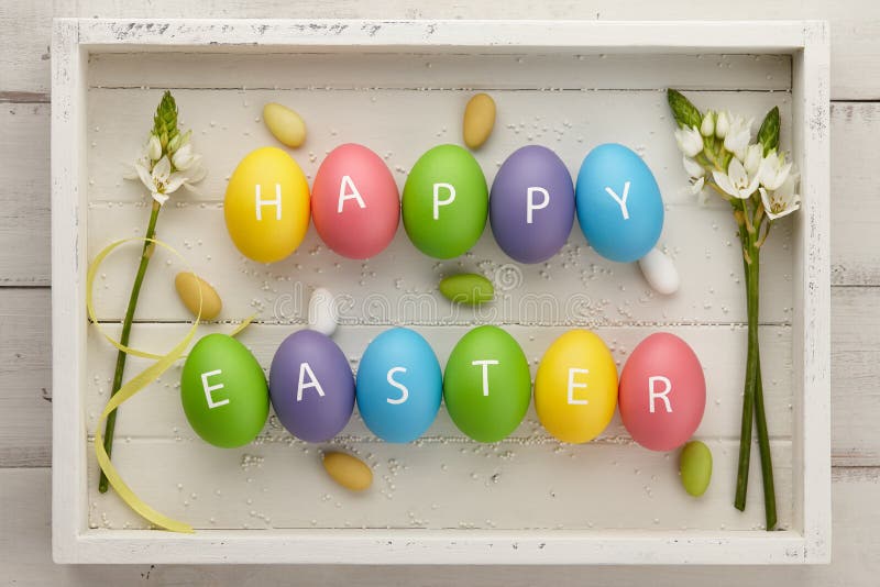Colorful Easter eggs with letters on white planks stock image Colorful Easter eggs with letters on white planks stock image
