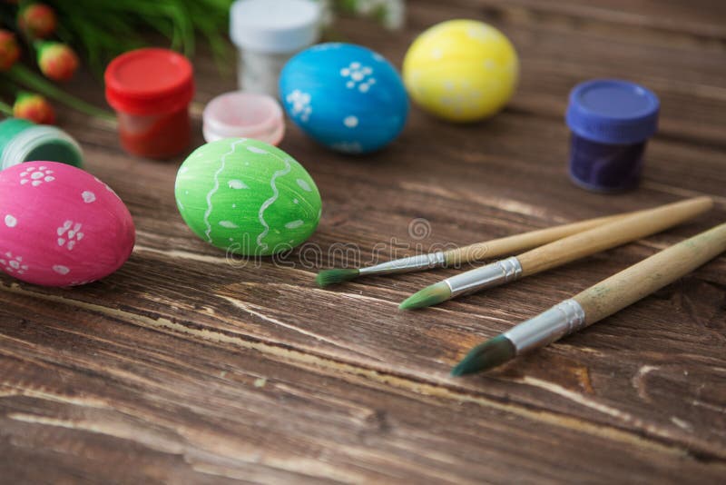 Colorful Easter Eggs, Paint Palette and Brushes on Wooden Table. Top ...