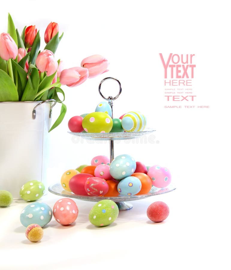 Colorful easter eggs with pink tulips on white