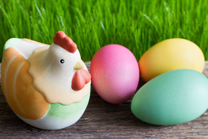 Colorful easter eggs on wooden plank and green grass stock images Colorful easter eggs on wooden plank and green grass stock images