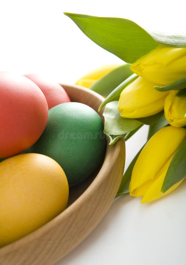 Colorful easter eggs and yellow tulips