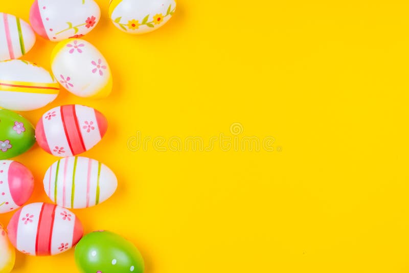 Colorful Easter Painted Eggs Background on Yellow Pastel Color