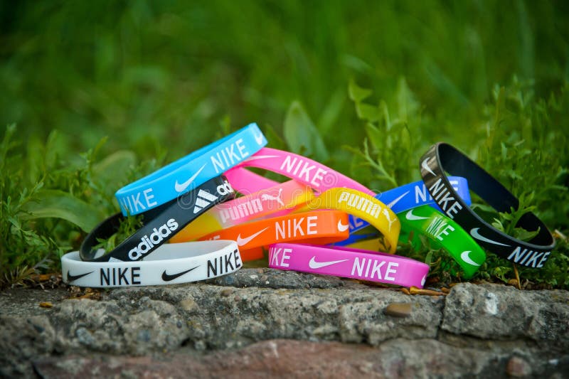 Colorful elastic rubber bracelets, wristbands with the labels of famous brands. Krasnoyarsk, Russia - May 14, 2015