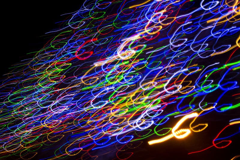 Colorful electric lights in motion over black