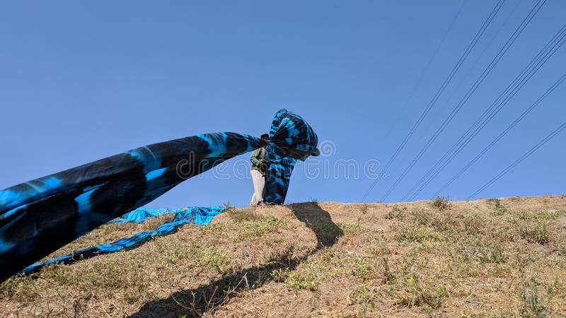 Colorful fabric drying after traditional dye process royalty free stock photography
