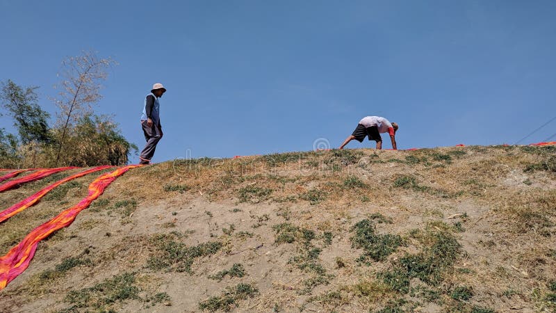 Colorful fabric drying after traditional dye process royalty free stock photos