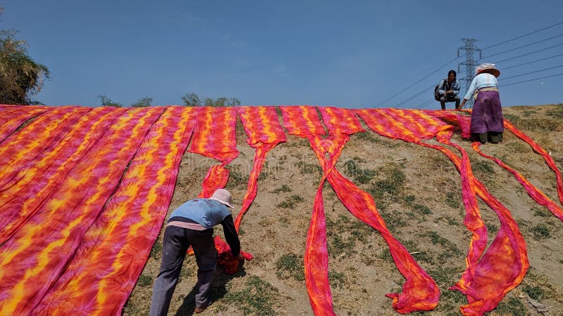 Colorful fabric drying after traditional dye process stock image