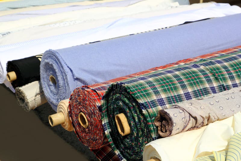 Colorful fabric rolls row in market shop royalty free stock photos