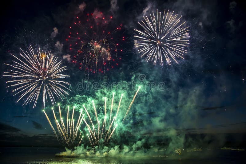 Colorful fireworks on the black sky background over-water. Colorful fireworks on the black sky background over-water