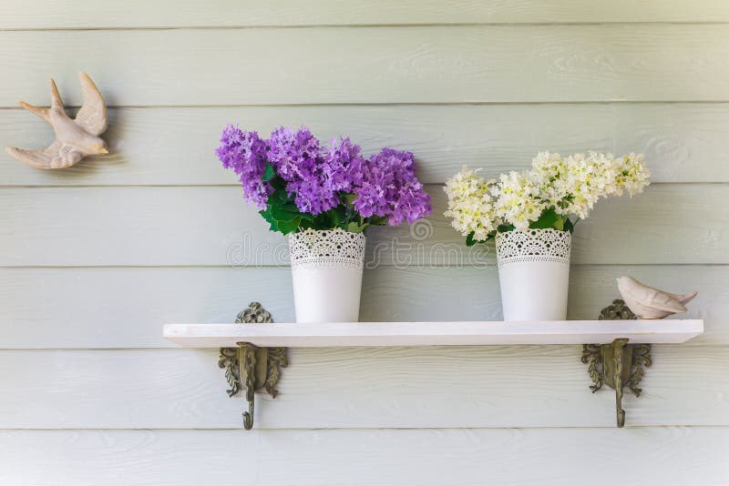 Colorful flowers in pots vintage on wall