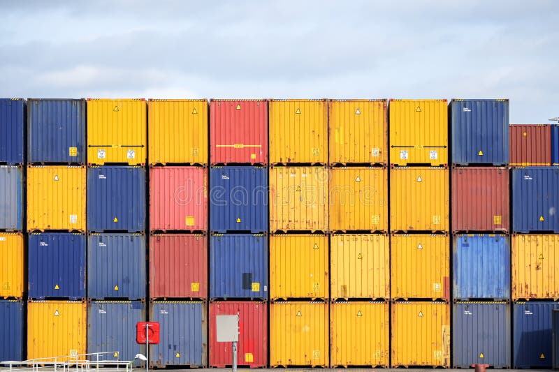 Colorful freight containers stacked up on the quay for shipping in the cargo port of Luebeck