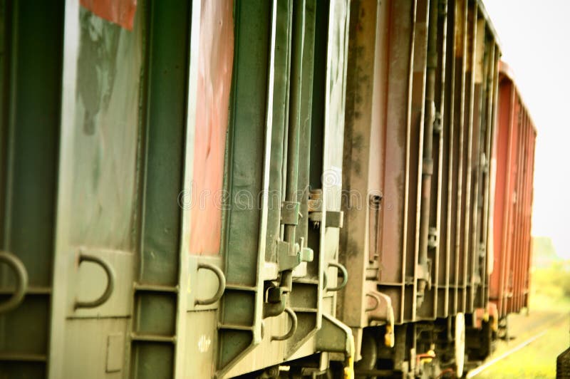 Colorful freight train wagons, close-up of metal wagons on a siding