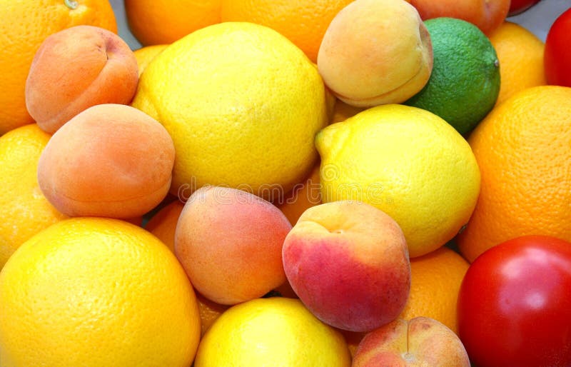 Colorful and healthy fresh fruits with many vitamins in summertime: apricots, lemons, tomatoes, oranges. Colorful and healthy fresh fruits with many vitamins in summertime: apricots, lemons, tomatoes, oranges