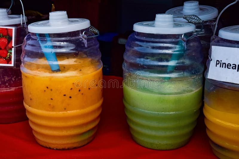 https://thumbs.dreamstime.com/b/colorful-fruit-drinks-jugs-sale-farmer-s-market-stall-juice-vendor-table-226459025.jpg