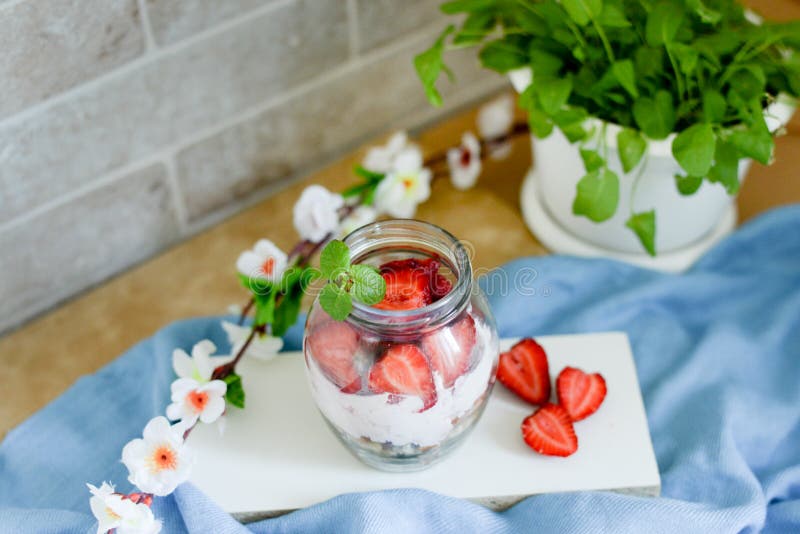 Colorful fruit salad in a jar on white and blue rustic wooden background.top view. Strawberry milkshake in jar royalty free stock photo Colorful fruit salad in a jar on white and blue rustic wooden background.top view. Strawberry milkshake in jar royalty free stock photo
