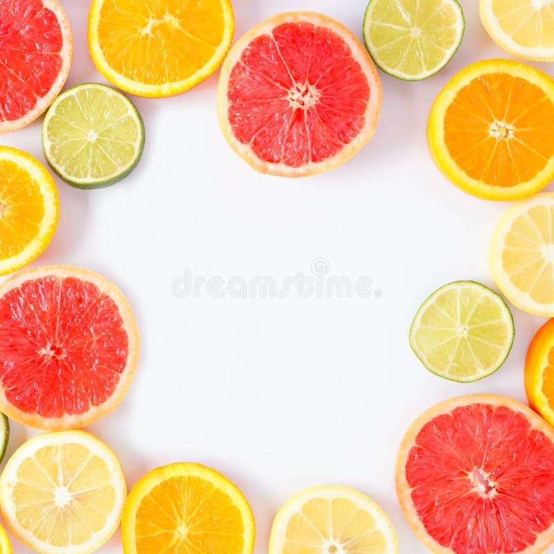 Colorful fruit square frame of citrus slices, top view over a white background royalty free stock image