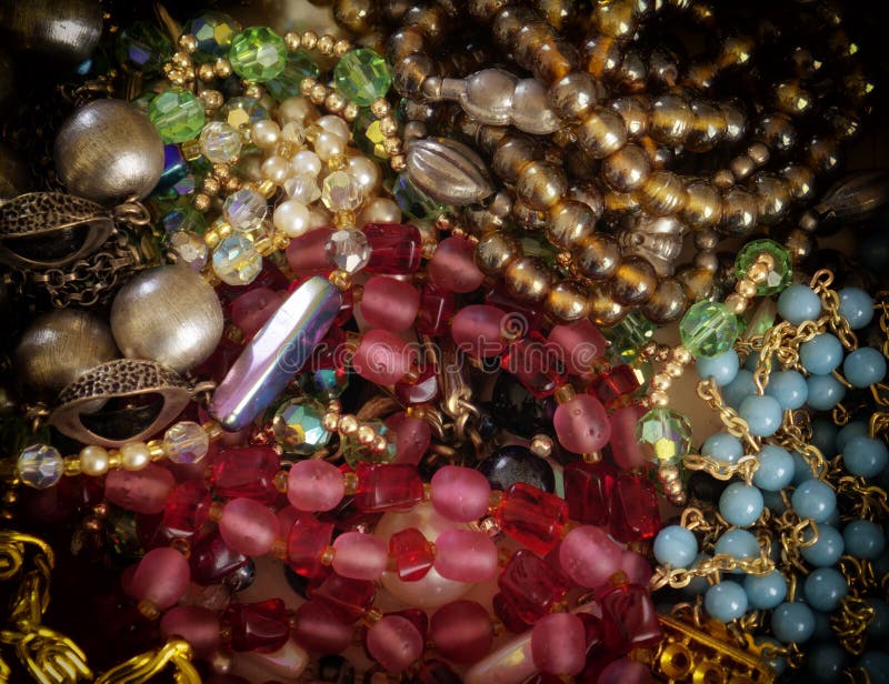 Colorful gems and golden fashion jewels closeup, top view royalty free stock photos