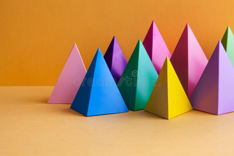 Colorful geometric abstract still life composition. Bright prism pyramid triangle shape figures. Violet yellow blue pink. Green red color objects, orange royalty free stock photography Colorful geometric abstract still life composition. Bright prism pyramid triangle shape figures. Violet yellow blue pink. Green red color objects, orange royalty free stock photography