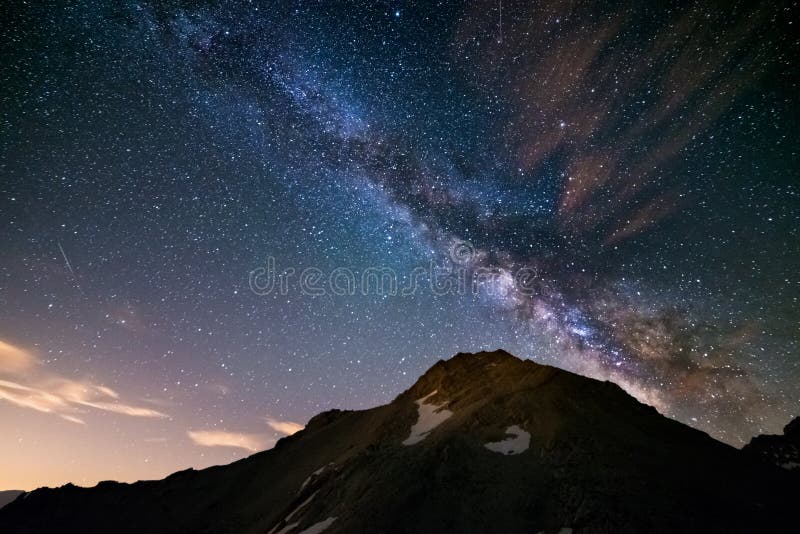 The colorful glowing core of the Milky Way and the starry sky captured at high altitude in summertime on the Italian Alps, Torino