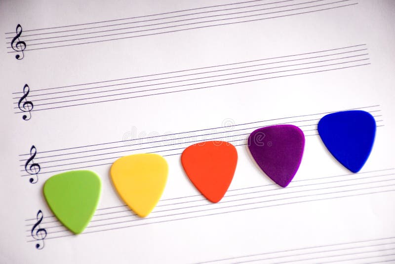 Colorful guitar pick on a blank sheet stock photos Colorful guitar pick on a blank sheet stock photos