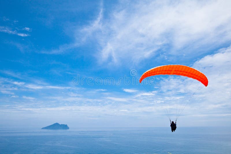 Colorful hang glider in sky