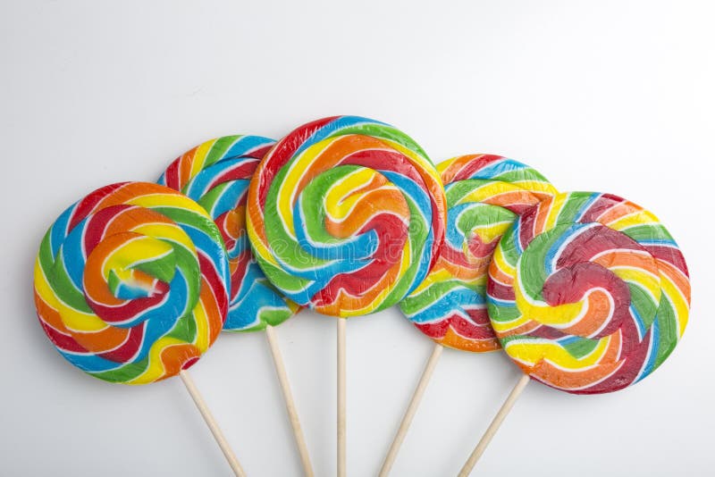 Colorful Hard Candy Lollipop on White Background. Rainbow Sweet Pattern
