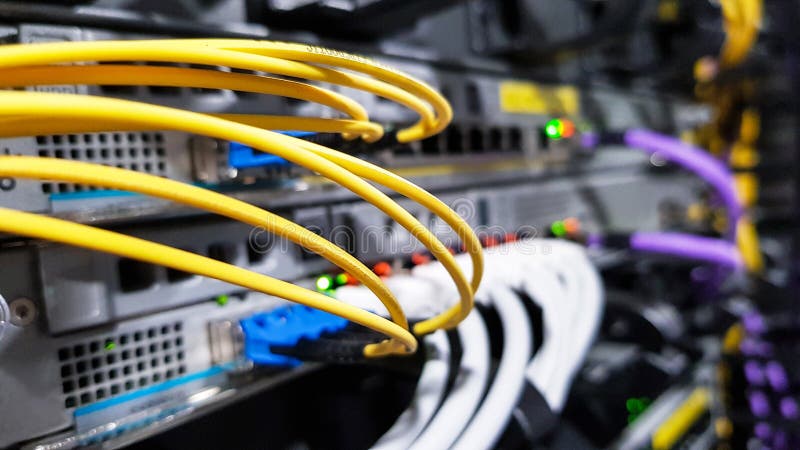 Colorful high speed optical fiber cables connected to the cloud network servers equipment switch inside modern big data center stock images