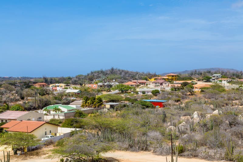 Aruba Desert Meets Ocean with Billowing Clouds in Blue Sky Stock Photo