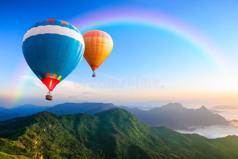 Colorful hot-air balloons flying over the mountain