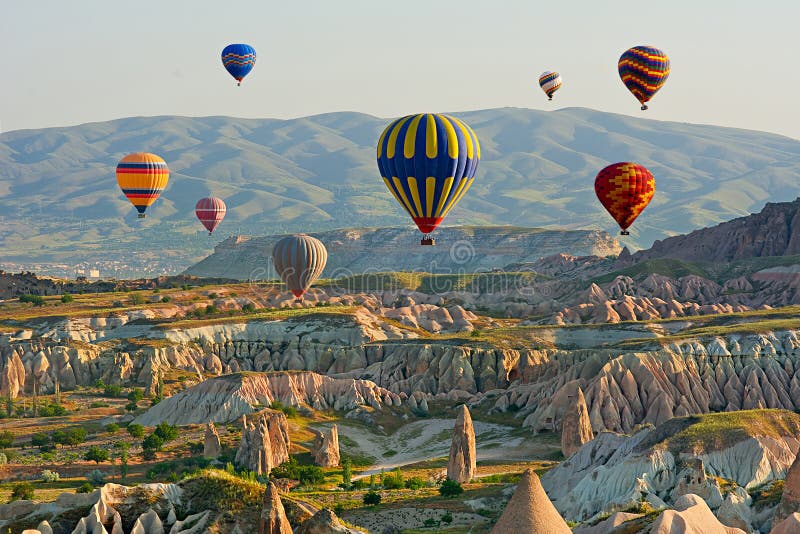 Colorful hot air balloons flying over the valley at Cappadocia stock photo Colorful hot air balloons flying over the valley at Cappadocia stock photo