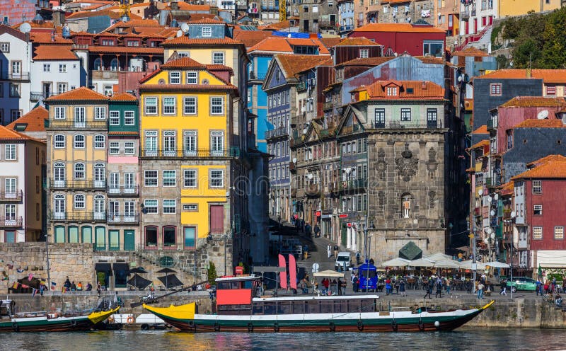 Colorful houses of Porto Ribeira, traditional facades, old multi-colored houses with red roof tiles on the embankment in the city