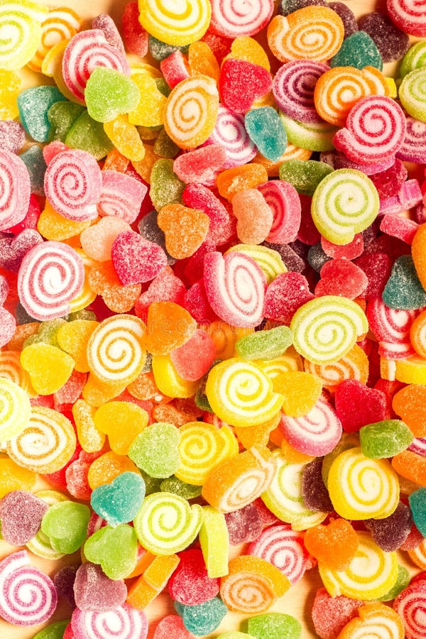 Colorful jellies and candies sweets heart-shaped background