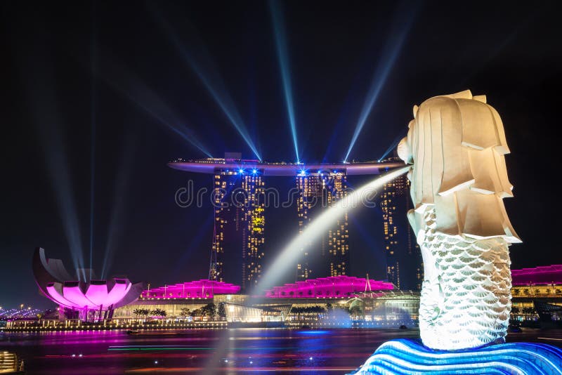 Singapore's Merlion statue watches over laser lights emanating from the Marina Bay Sands Hotel. The nightly event illuminates the Marina Bay in a spectacular display of sight and sound. Singapore's Merlion statue watches over laser lights emanating from the Marina Bay Sands Hotel. The nightly event illuminates the Marina Bay in a spectacular display of sight and sound.