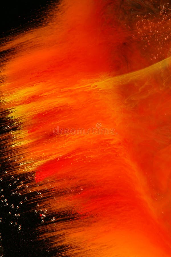 Colorful liquid art background. A view of red and yellow in dissolving in water in front of a black background. Air bubbles add unique texture to the liquid royalty free stock images Colorful liquid art background. A view of red and yellow in dissolving in water in front of a black background. Air bubbles add unique texture to the liquid royalty free stock images