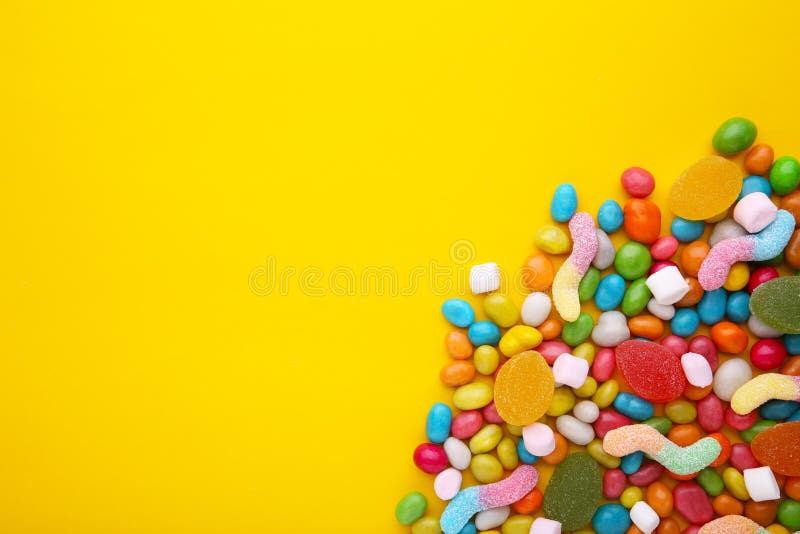 Colorful Lollipops and Different Colored Round Candy on Yellow