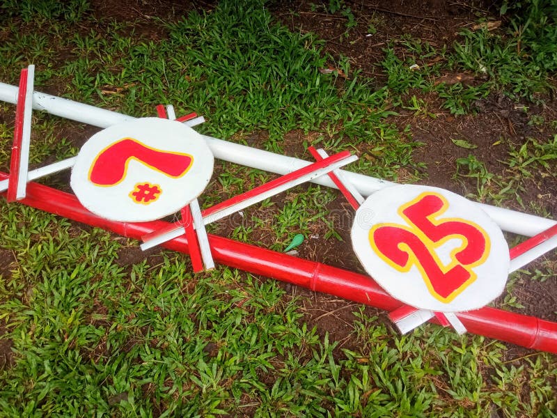 Colorful Marker Numbers on Painted Bamboo PolesDescription:This image shows two circular signs displaying stock photo