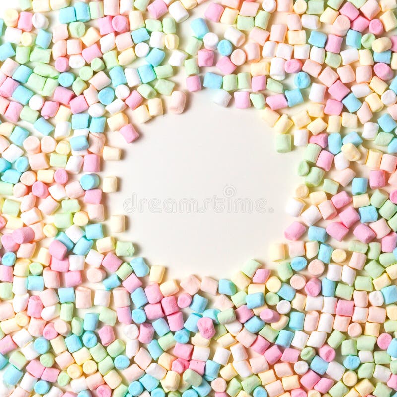 Colorful mini marshmallows background frame. Copy space for text. stock photos