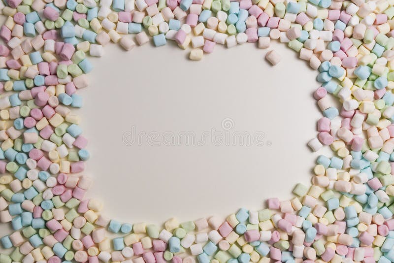 Colorful mini marshmallows background frame. Copy space for text. royalty free stock photos