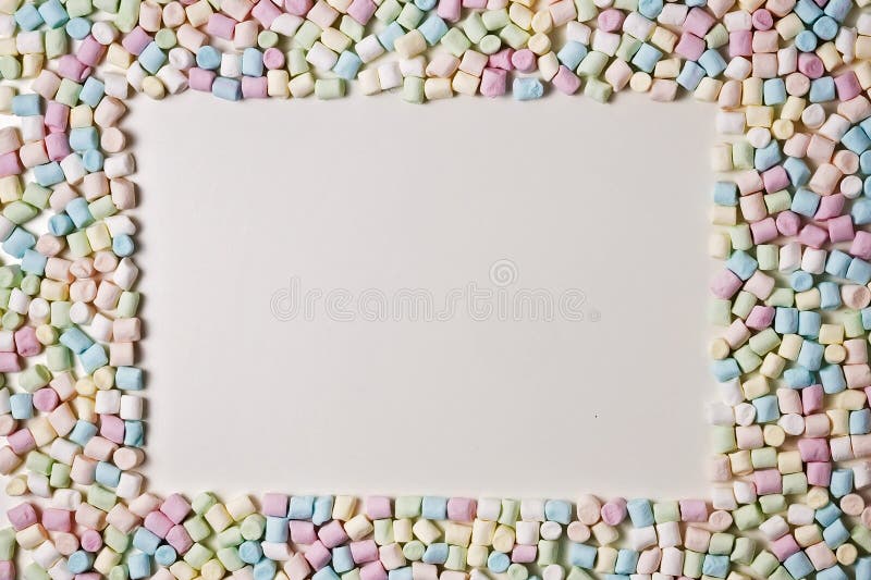 Colorful mini marshmallows background frame. Copy space for text. stock images