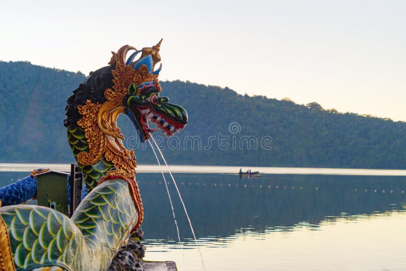 Colorful Naga or serpent statue fountain in front of Ulun Danu Bratan Temple and lake in Bali. It is one of the most popular of stock image