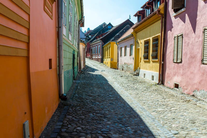 Colorful narrow medieval street on a bright spring day in Sighisoara stock photos Colorful narrow medieval street on a bright spring day in Sighisoara stock photos